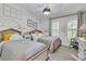 Bright bedroom with twin beds, cloud decor, and natural light from shuttered windows at 4196 Balmoral Castle Ct, Las Vegas, NV 89141
