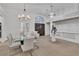 Bright dining area with modern chandelier, high ceilings and seamless flow into the living spaces at 4196 Balmoral Castle Ct, Las Vegas, NV 89141