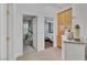 Bright entryway showcasing views into two bedrooms, storage cabinet and decor at 4196 Balmoral Castle Ct, Las Vegas, NV 89141