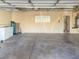 Spacious garage offering ample storage with shelving, clean flooring, and neutral walls at 4196 Balmoral Castle Ct, Las Vegas, NV 89141