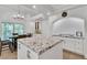 Open kitchen with granite countertops, stainless steel appliances, modern lighting, and sliding glass doors at 4196 Balmoral Castle Ct, Las Vegas, NV 89141