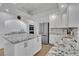 Bright kitchen features white cabinets, granite countertops, stainless steel appliances and center island at 4196 Balmoral Castle Ct, Las Vegas, NV 89141