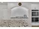 Updated kitchen features granite counters, white cabinets, tile backsplash and stainless steel appliances at 4196 Balmoral Castle Ct, Las Vegas, NV 89141