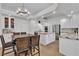 Open kitchen and dining area with granite countertops, stainless steel appliances, and modern lighting at 4196 Balmoral Castle Ct, Las Vegas, NV 89141