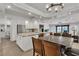 Open kitchen and dining area features modern lighting, granite countertops, and stainless steel appliances at 4196 Balmoral Castle Ct, Las Vegas, NV 89141