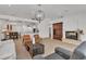 Open-concept living room flows to kitchen, dining area, and fireplace with modern decor at 4196 Balmoral Castle Ct, Las Vegas, NV 89141