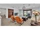 Bright living room features neutral flooring, furniture, fireplace, and outdoor views at 4196 Balmoral Castle Ct, Las Vegas, NV 89141