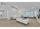 Spacious living room offers stylish white furnishings, large windows, and light tile floors at 4196 Balmoral Castle Ct, Las Vegas, NV 89141