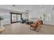 Bright living room with modern furnishings, light tile flooring and access to outdoor living at 4196 Balmoral Castle Ct, Las Vegas, NV 89141