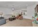 Open living area leads to kitchen and dining area, with neutral tile and modern decor at 4196 Balmoral Castle Ct, Las Vegas, NV 89141