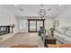 Open living room featuring tile floors, gas fireplace, and access to the pool through sliding glass doors at 4196 Balmoral Castle Ct, Las Vegas, NV 89141