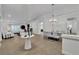 Open floor plan with living and dining areas features neutral decor, high ceilings, and ample lighting at 4196 Balmoral Castle Ct, Las Vegas, NV 89141