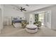 Bright main bedroom features plush carpet, neutral walls, ceiling fan, and access to an outdoor patio at 4196 Balmoral Castle Ct, Las Vegas, NV 89141