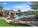 Gorgeous backyard pool area with tanning deck and inviting lounge chairs, ideal for outdoor enjoyment at 4196 Balmoral Castle Ct, Las Vegas, NV 89141