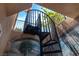 Intriguing spiral staircase in a courtyard featuring a hand-painted tropical mural at 4196 Balmoral Castle Ct, Las Vegas, NV 89141