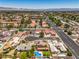 Capture the charm of this neighborhood with homes, desert landscaping, and inviting pools, all in an appealing aerial shot at 4475 Harmony Ct, Las Vegas, NV 89121