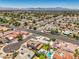 Picturesque neighborhood aerial view featuring landscaped streets and homes with private pools against a mountain backdrop at 4475 Harmony Ct, Las Vegas, NV 89121