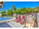 Private backyard features a sparkling pool, lush landscaping, and an inviting swing set perfect for relaxing outdoors at 4475 Harmony Ct, Las Vegas, NV 89121