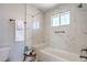 Bright bathroom features tub and shower combo with tiled walls and seat and convenient grab bars at 4475 Harmony Ct, Las Vegas, NV 89121