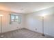 Bright bedroom featuring a window with blue curtains and minimalist design with carpet flooring at 4475 Harmony Ct, Las Vegas, NV 89121