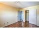 Bedroom with wood floors includes access to a walk-in closet and an ensuite bathroom at 4475 Harmony Ct, Las Vegas, NV 89121