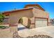 Front exterior of a home showing the driveway leading to an arched entry and a well-maintained two car garage at 4475 Harmony Ct, Las Vegas, NV 89121