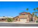 Charming two-story home features a well-manicured lawn, mature palm trees, and an attached two-car garage at 4475 Harmony Ct, Las Vegas, NV 89121