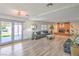 Bright living room featuring a brick fireplace, plush seating, and outdoor access at 4475 Harmony Ct, Las Vegas, NV 89121