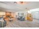 Spacious living room with wood-look floors, brick fireplace, and neutral-toned furniture at 4475 Harmony Ct, Las Vegas, NV 89121