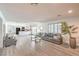 Open-concept living room connected to a modern kitchen with stainless steel appliances at 4475 Harmony Ct, Las Vegas, NV 89121
