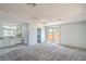 Bright main bedroom with carpet, ceiling fan, ensuite bathroom, and double door entry to balcony at 4475 Harmony Ct, Las Vegas, NV 89121