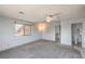 Large main bedroom with carpet, ceiling fan, window, and access to ensuite bathroom at 4475 Harmony Ct, Las Vegas, NV 89121