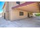 Spacious covered patio attached to a well-maintained home with a smooth concrete floor and mature landscaping at 4475 Harmony Ct, Las Vegas, NV 89121