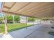 Large covered patio overlooking a backyard with lush green grass and a refreshing swimming pool at 4475 Harmony Ct, Las Vegas, NV 89121
