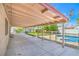 Large covered patio overlooks a well-maintained backyard with a pool and plenty of space for outdoor entertaining at 4475 Harmony Ct, Las Vegas, NV 89121