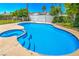 Sparkling blue pool and spa area offering a relaxing and private outdoor oasis with tropical landscaping at 4475 Harmony Ct, Las Vegas, NV 89121