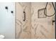 Stylish bathroom with marble-patterned tile shower, modern fixtures, and convenient grab bar at 4475 Harmony Ct, Las Vegas, NV 89121