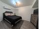 Cozy bedroom with hardwood-style floors and a modern ceiling fan at 460 Elm Dr # 103, Las Vegas, NV 89169