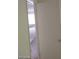 An open door from a hallway with view of an upstairs white banister and hallway at 4760 Woodridge Rd, Las Vegas, NV 89121