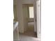 Hallway with beige carpeting, leading to a room with a window at 4760 Woodridge Rd, Las Vegas, NV 89121