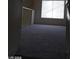 Carpeted upstairs landing with a large window offering natural light at 4760 Woodridge Rd, Las Vegas, NV 89121