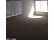 Bright living room with carpeted floors and large windows at 4760 Woodridge Rd, Las Vegas, NV 89121