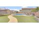 Backyard view featuring a pool, turfed area, and secure pool fence at 482 Painted Sage Ct, Henderson, NV 89015