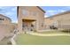 Large turfed backyard with patio and pool with balcony above at 482 Painted Sage Ct, Henderson, NV 89015