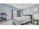 Bright bedroom with light blue walls, vaulted ceiling, and sliding glass door with gray curtains at 482 Painted Sage Ct, Henderson, NV 89015