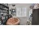 Relaxing bedroom with organized shelving, comfy chair, and a sunlit window at 482 Painted Sage Ct, Henderson, NV 89015