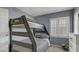 Bedroom featuring a bunk bed, neutral wall color, plantation shutters, and decor at 482 Painted Sage Ct, Henderson, NV 89015