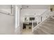 View of the entryway featuring a staircase, coat hooks, and a view of the living room at 482 Painted Sage Ct, Henderson, NV 89015