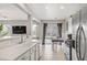 Well-lit kitchen featuring stainless steel appliances and open layout to living area at 482 Painted Sage Ct, Henderson, NV 89015