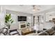 Neutral-toned living room with a ceiling fan, a fireplace, and view of a dining area through an opening at 482 Painted Sage Ct, Henderson, NV 89015